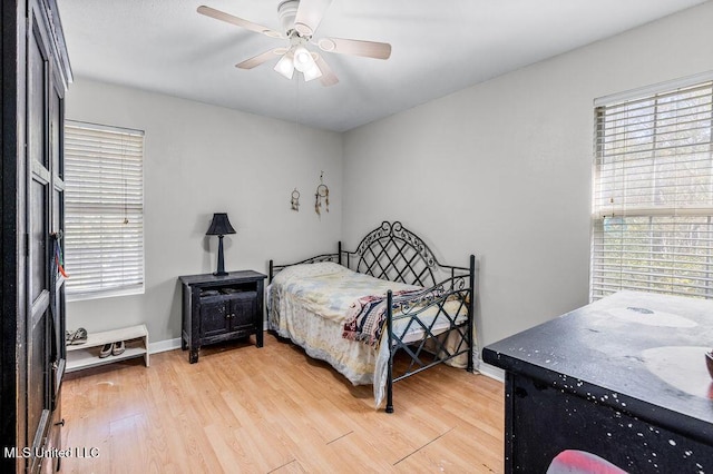 bedroom with ceiling fan and light hardwood / wood-style flooring