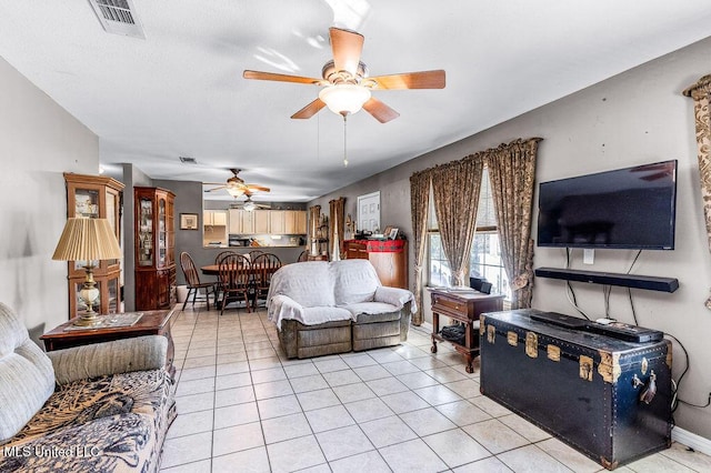 tiled living room with ceiling fan