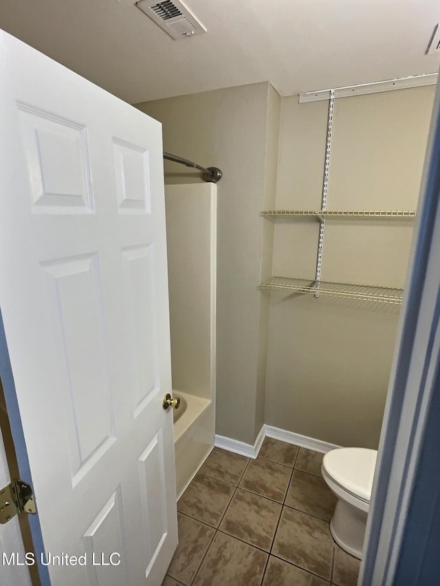 1204 Dorothy St, Ocean Springs, MS 39564 - full bath featuring toilet, bathtub / shower combination, baseboards, and tile patterned floors