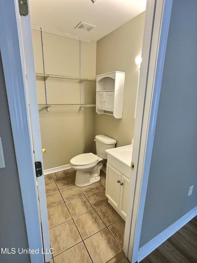 1204 Dorothy St, Ocean Springs, MS 39564 - bathroom featuring vanity, toilet, tile patterned flooring, and baseboards
