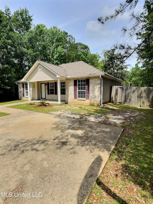 1204 Dorothy St, Ocean Springs, MS 39564 - view of front facade with brick siding, covered porch, and roof with shingles