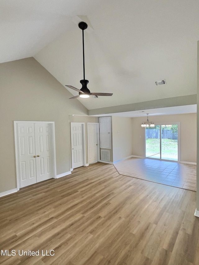 1204 Dorothy St, Ocean Springs, MS 39564 - unfurnished bedroom with a chandelier, high vaulted ceiling, light wood-style floors, two closets, and baseboards