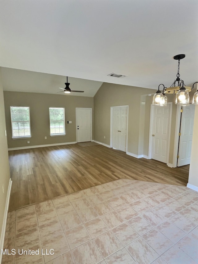 1204 Dorothy St, Ocean Springs, MS 39564 - unfurnished room featuring a chandelier, lofted ceiling, baseboards, light wood-style flooring, and ceiling fan