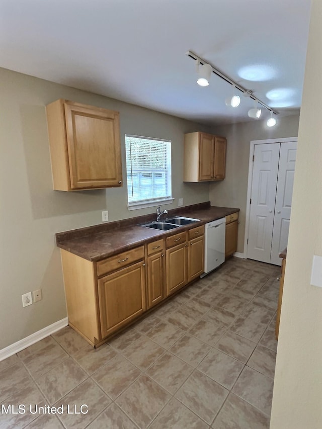 1204 Dorothy St, Ocean Springs, MS 39564 - kitchen featuring dishwasher, a sink, dark countertops, and rail lighting