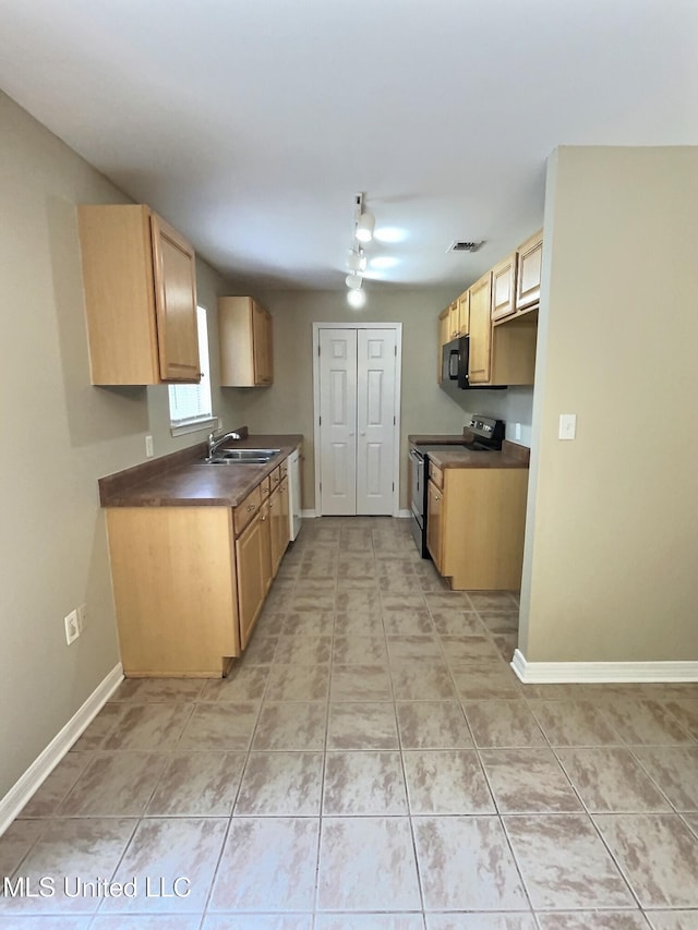 1204 Dorothy St, Ocean Springs, MS 39564 - kitchen with stainless steel range with electric cooktop, black microwave, dark countertops, a sink, and baseboards