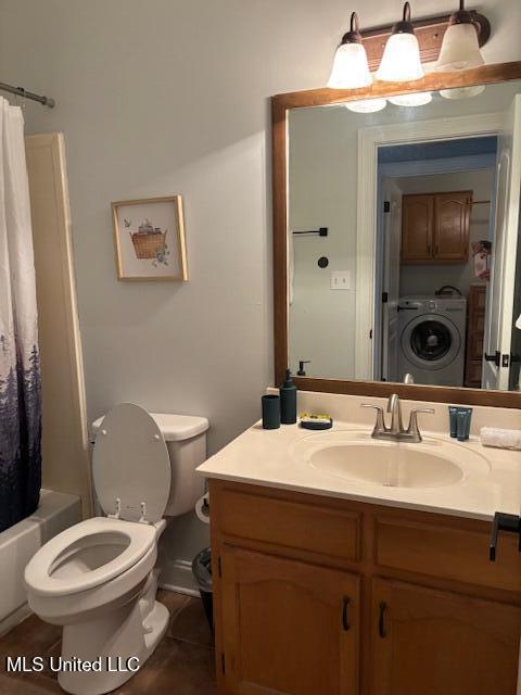 220 Forked Creek Pkwy, Hernando, MS 38632 - full bath with washer / clothes dryer, vanity, toilet, shower / bath combo with shower curtain, and tile patterned flooring