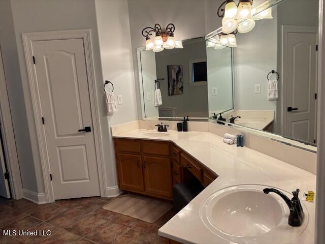 220 Forked Creek Pkwy, Hernando, MS 38632 - bathroom featuring double vanity, a chandelier, and baseboards
