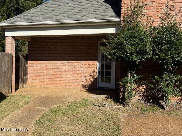 220 Forked Creek Pkwy, Hernando, MS 38632 - view of side of home featuring a shingled roof and brick siding