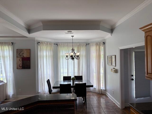 220 Forked Creek Pkwy, Hernando, MS 38632 - dining room with a chandelier, baseboards, healthy amount of natural light, dark tile patterned flooring, and ornamental molding