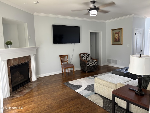 220 Forked Creek Pkwy, Hernando, MS 38632 - living room with wood finished floors, a ceiling fan, ornamental molding, a tiled fireplace, and baseboards
