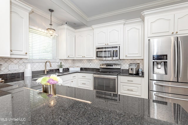 kitchen with appliances with stainless steel finishes, white cabinetry, dark stone countertops, and sink