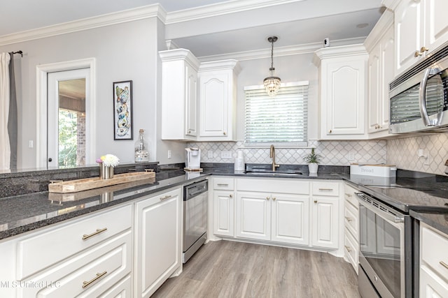 kitchen featuring ornamental molding, sink, white cabinetry, and stainless steel appliances