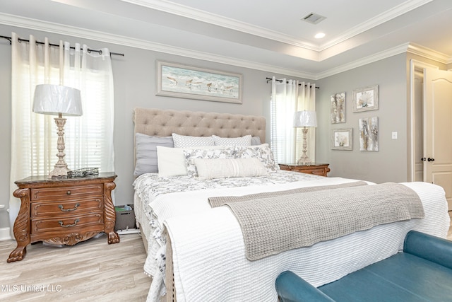 bedroom with light hardwood / wood-style flooring, ornamental molding, and multiple windows