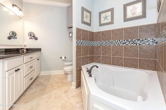 bathroom with vanity, toilet, and a tub