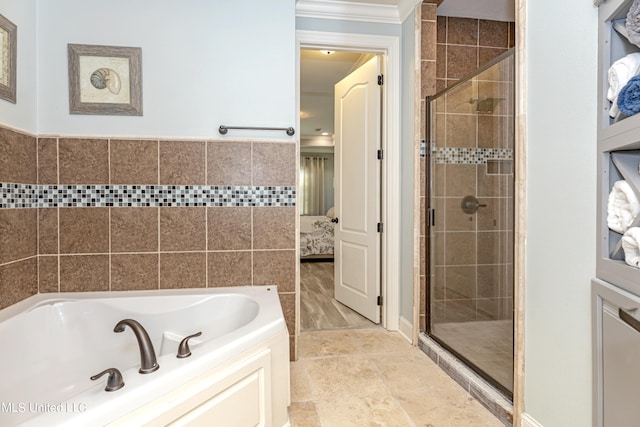 bathroom featuring tile walls, separate shower and tub, and ornamental molding