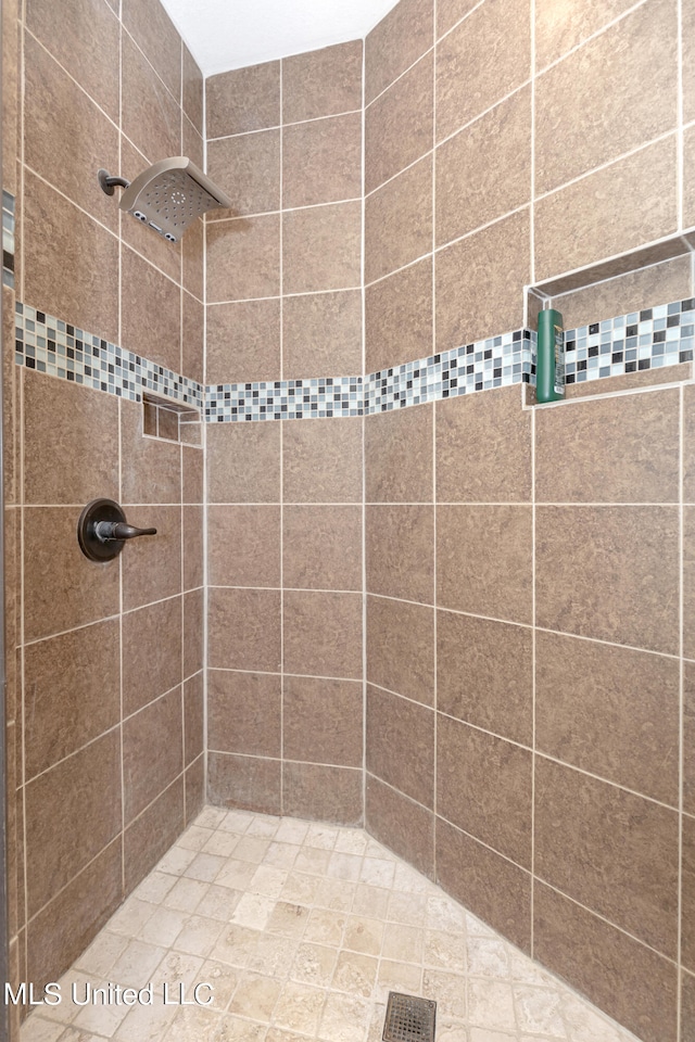 bathroom with a tile shower