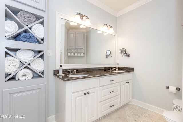 bathroom with vanity, toilet, ornamental molding, and tile patterned flooring