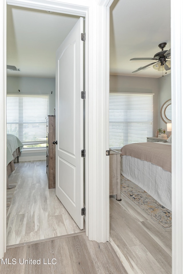 corridor with light hardwood / wood-style floors