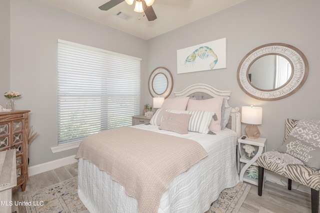 bedroom with ceiling fan and light hardwood / wood-style flooring