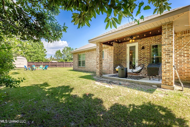 view of yard featuring a storage shed and a patio area