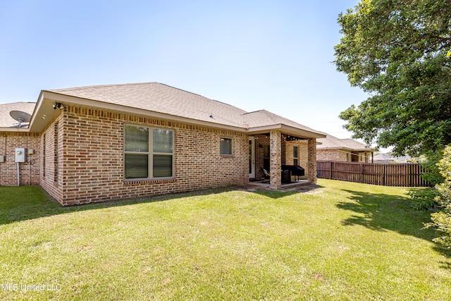 back of property featuring a yard