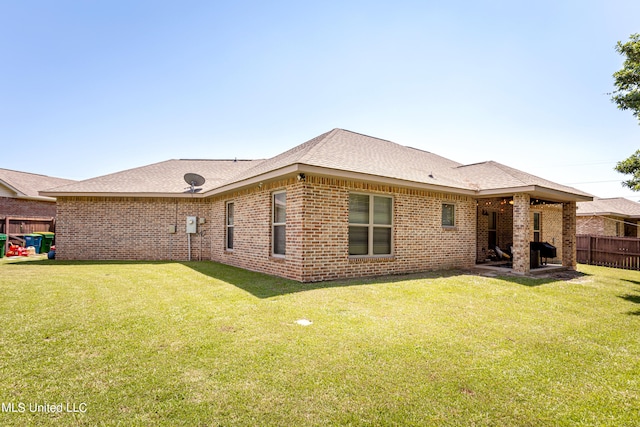 rear view of house featuring a lawn