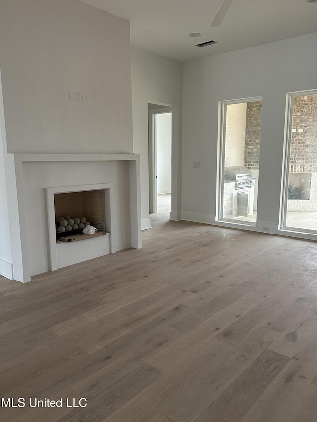 unfurnished living room with hardwood / wood-style flooring