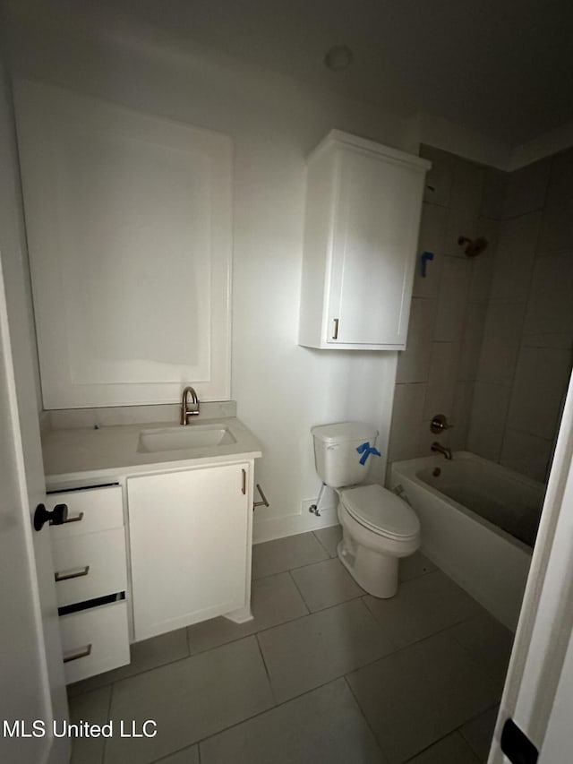 full bathroom featuring tile patterned flooring, vanity, tiled shower / bath, and toilet