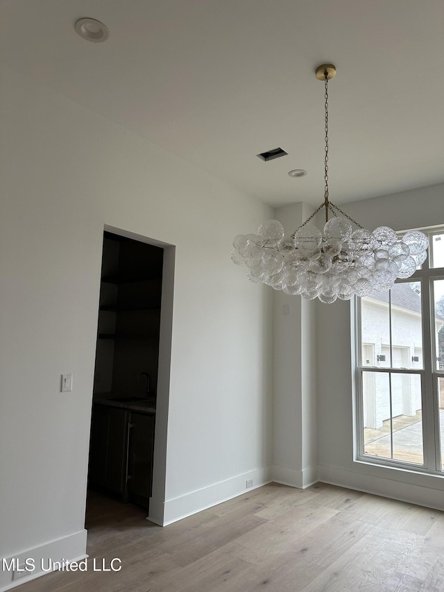 unfurnished dining area with hardwood / wood-style flooring and sink