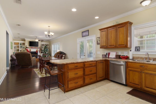 kitchen featuring kitchen peninsula, ornamental molding, sink, dishwasher, and light hardwood / wood-style floors