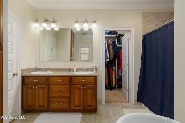 bathroom with walk in shower, tile patterned flooring, vanity, and ornamental molding