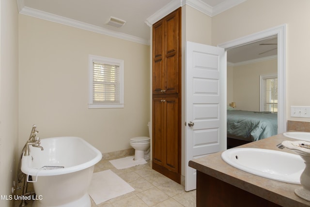 bathroom featuring a washtub, tile patterned flooring, toilet, vanity, and ornamental molding