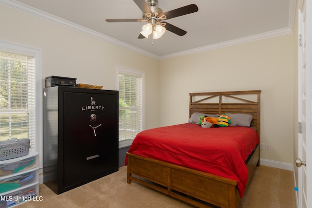 carpeted bedroom with ceiling fan, ornamental molding, and multiple windows