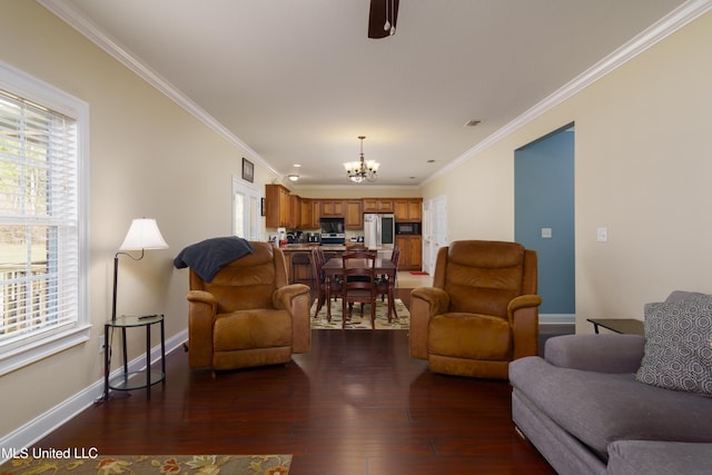 living room featuring dark hardwood / wood-style floors, ornamental molding, and a notable chandelier