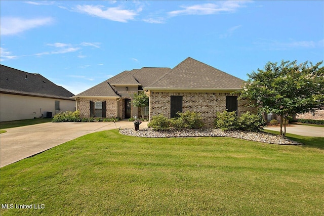 107 Sweetbriar Cir, Canton, MS 39046 - french country home with a front yard, brick siding, and roof with shingles