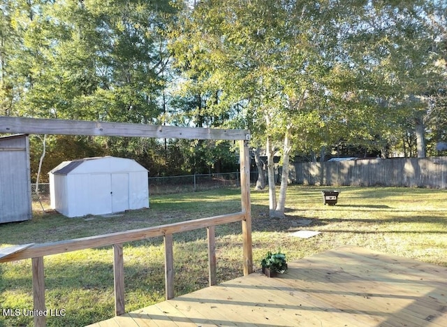 view of yard featuring a wooden deck and a shed