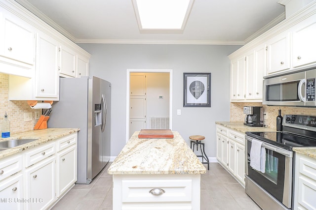 kitchen with stainless steel appliances, light tile patterned floors, tasteful backsplash, and ornamental molding