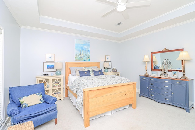 bedroom featuring light carpet, crown molding, a raised ceiling, and a ceiling fan