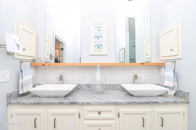 full bathroom with backsplash and double vanity