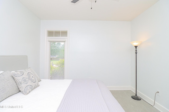 carpeted bedroom featuring baseboards and a ceiling fan