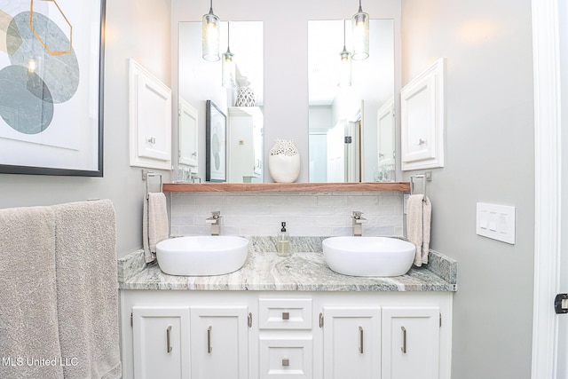 bathroom with decorative backsplash and double vanity