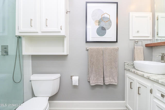 bathroom with toilet, vanity, decorative backsplash, and a shower