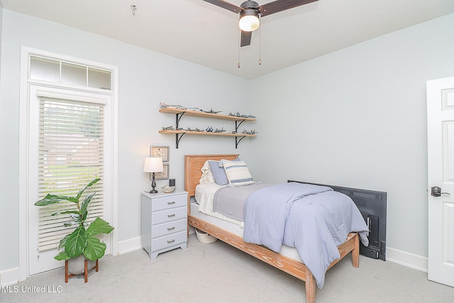 bedroom featuring light carpet, baseboards, and a ceiling fan