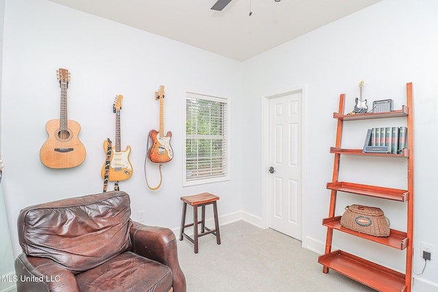 living area featuring carpet, ceiling fan, and baseboards