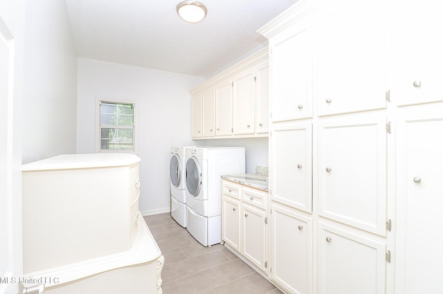 washroom with cabinet space and separate washer and dryer