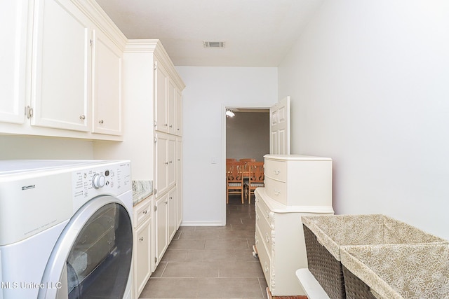 laundry room featuring washer / dryer, cabinet space, and light tile patterned floors