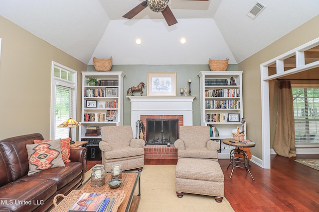 living area featuring lofted ceiling, a ceiling fan, wood finished floors, a fireplace, and recessed lighting
