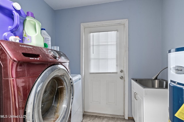 laundry room featuring a sink, cabinet space, and independent washer and dryer