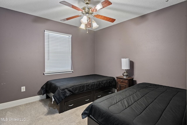 carpeted bedroom with baseboards and a ceiling fan