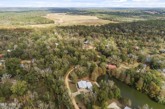 drone / aerial view featuring a water view and a wooded view